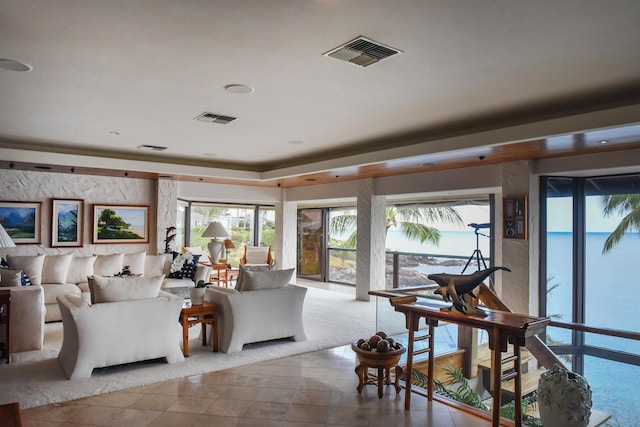 tiled living room with a water view