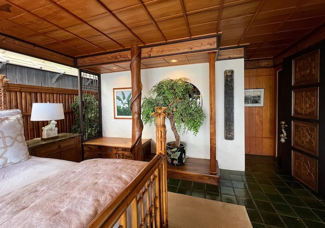 bedroom featuring wooden ceiling and wooden walls