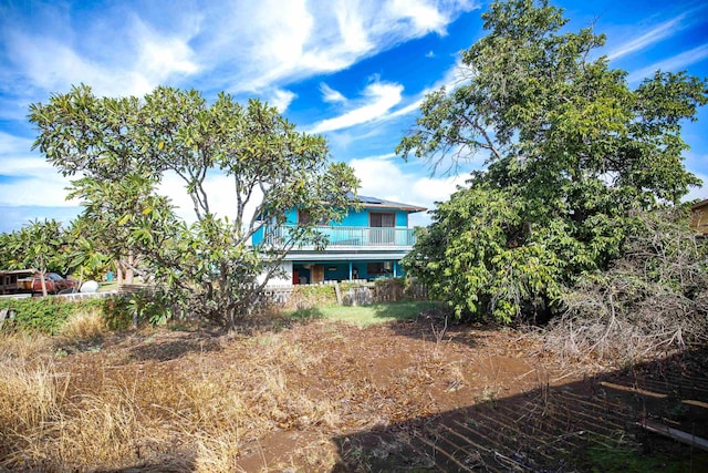 rear view of property featuring a balcony