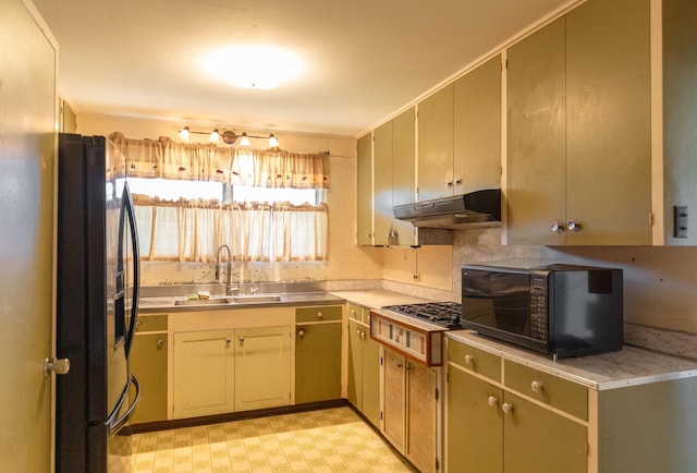 kitchen featuring decorative backsplash, sink, and black appliances