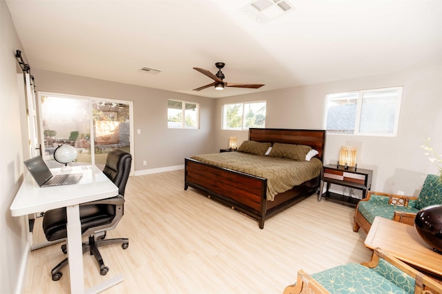 bedroom featuring light wood-style floors, access to outside, visible vents, and baseboards