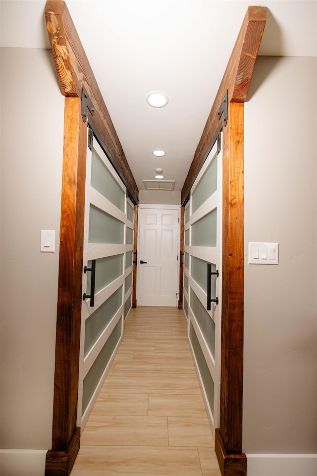 hallway with light wood-style floors and recessed lighting