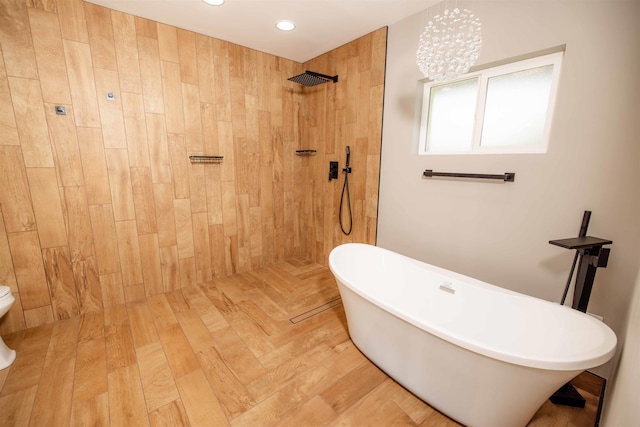 bathroom featuring a freestanding tub, tiled shower, and recessed lighting