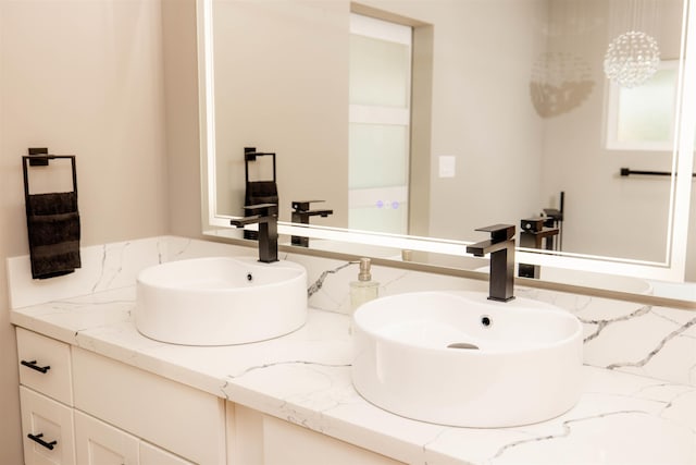 bathroom featuring a sink and double vanity