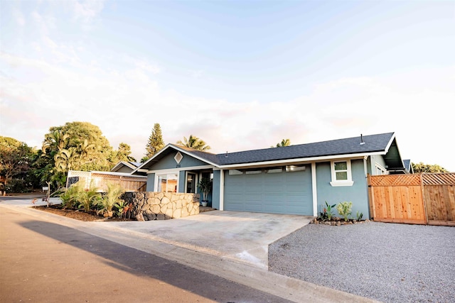 ranch-style house with an attached garage, fence, concrete driveway, and stucco siding