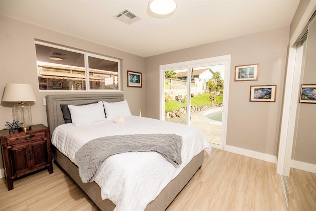 bedroom featuring access to outside, light wood-type flooring, visible vents, and baseboards