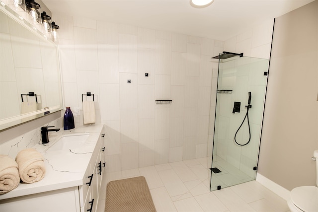 full bathroom with toilet, a tile shower, and vanity