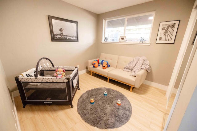 sitting room featuring baseboards and wood finished floors