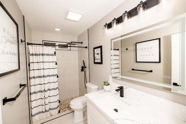 bathroom featuring toilet, a tile shower, and vanity