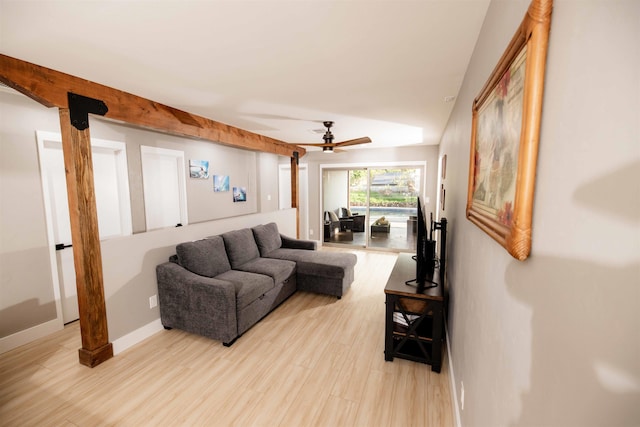 living room featuring a ceiling fan, light wood-type flooring, and baseboards