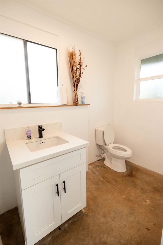 half bathroom featuring vanity, toilet, and unfinished concrete floors