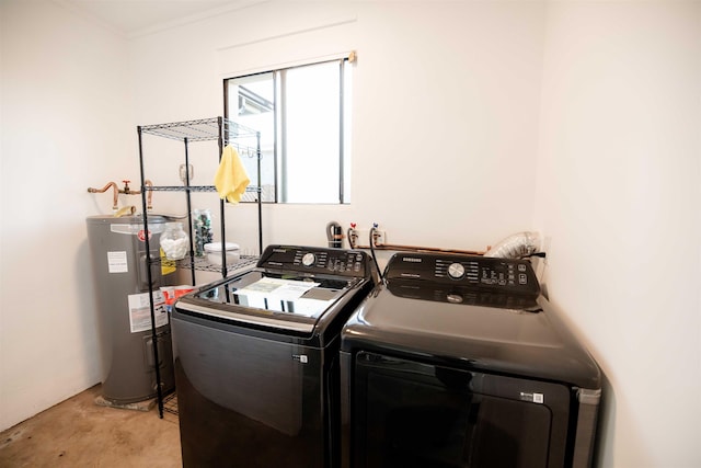 laundry room with laundry area, washing machine and dryer, and electric water heater