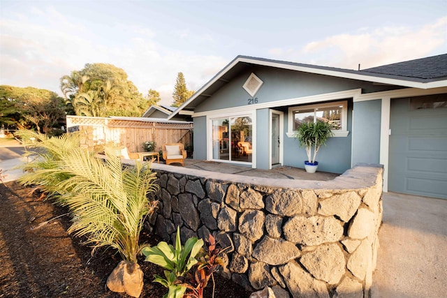 exterior space featuring fence and stucco siding