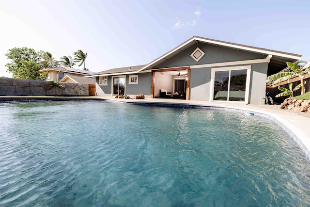 view of pool with a fenced in pool, fence, a patio, and ceiling fan