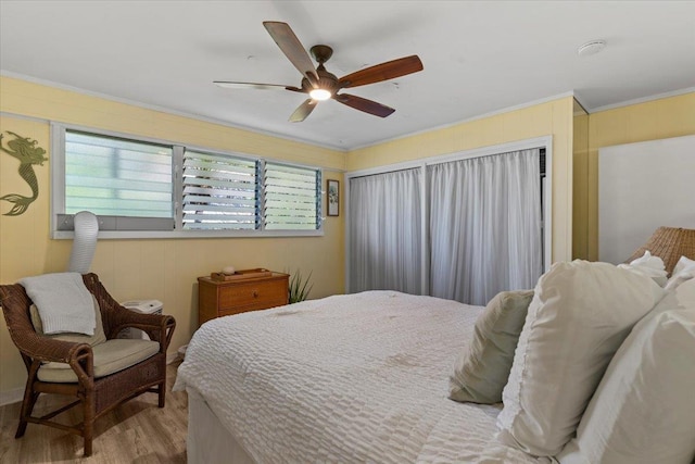 bedroom with ceiling fan, ornamental molding, and light hardwood / wood-style flooring