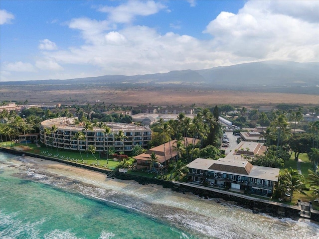 birds eye view of property featuring a water view and a beach view