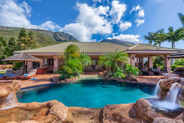 view of swimming pool featuring a mountain view, a patio, and pool water feature