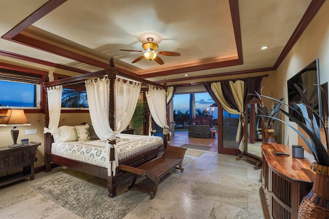 bedroom featuring ornamental molding, a tray ceiling, and access to outside