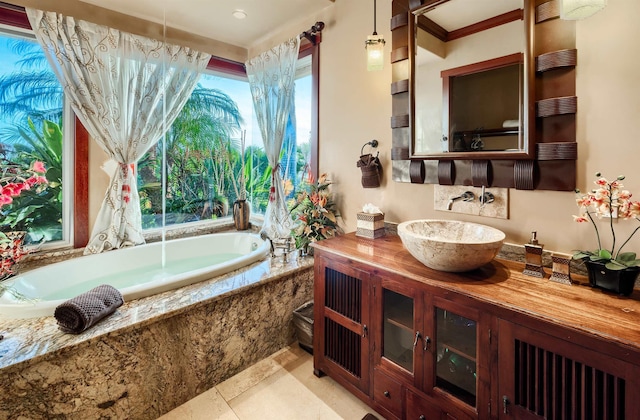 bathroom with tiled tub and vanity