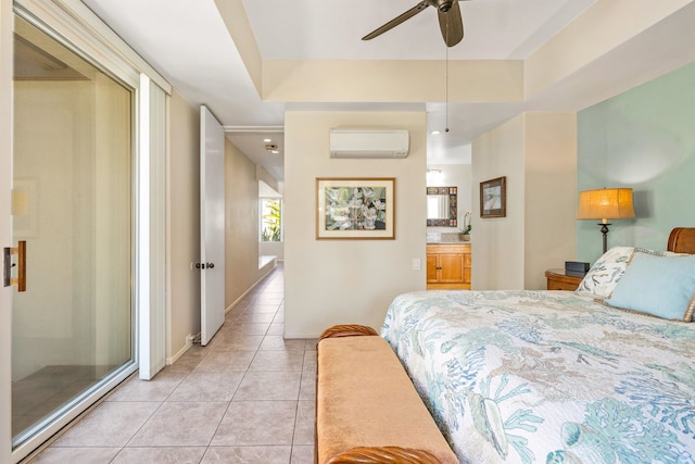 tiled bedroom with a raised ceiling, ceiling fan, a wall unit AC, and ensuite bathroom