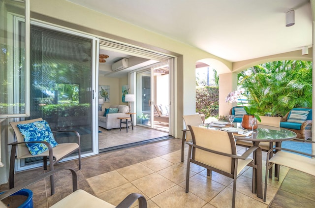 tiled dining space with an AC wall unit