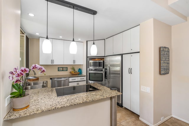 kitchen featuring light tile floors, white cabinets, stainless steel appliances, kitchen peninsula, and pendant lighting