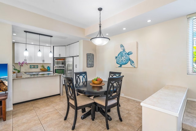 tiled dining area featuring a healthy amount of sunlight