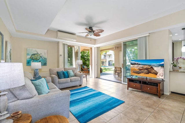 tiled living room with plenty of natural light, ceiling fan, and a wall mounted AC