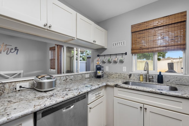 kitchen with dishwasher, a sink, a wealth of natural light, and white cabinets