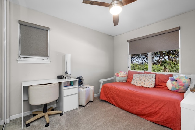 bedroom with ceiling fan, baseboards, and light colored carpet