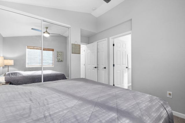 bedroom with a closet, vaulted ceiling, baseboards, and ceiling fan