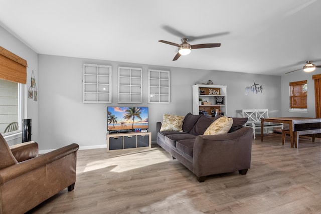 living room with baseboards, a ceiling fan, and wood finished floors