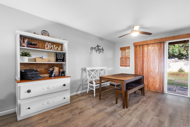 dining area with a ceiling fan, light wood-type flooring, and baseboards