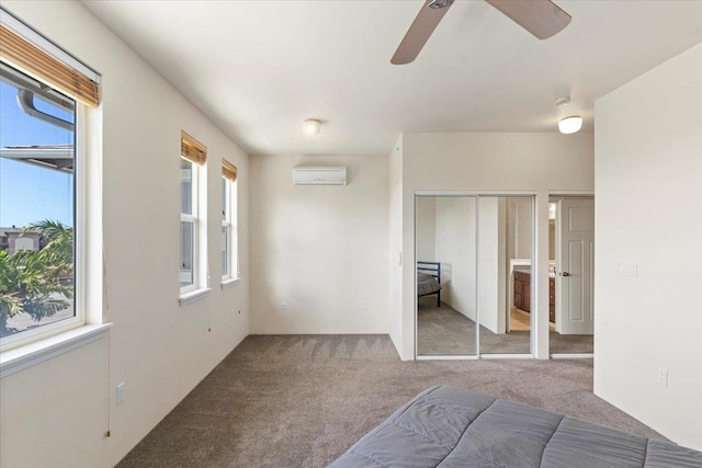 unfurnished bedroom featuring ceiling fan, light colored carpet, and an AC wall unit