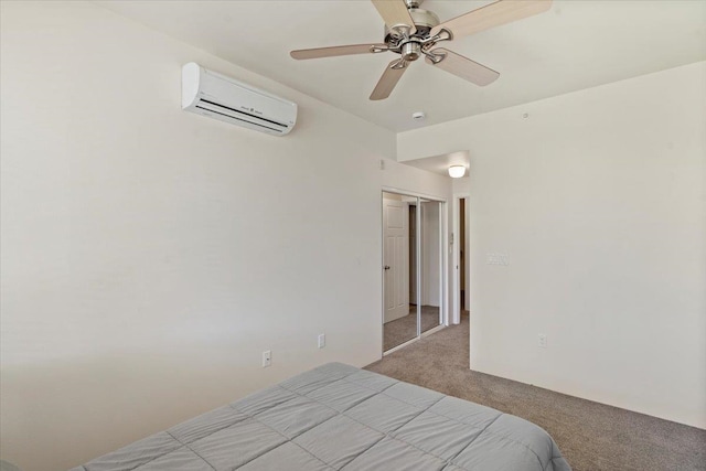 carpeted bedroom with an AC wall unit, a closet, and ceiling fan