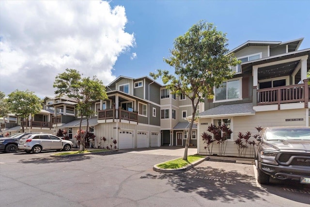 townhome / multi-family property with a balcony and a garage