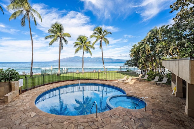 view of pool featuring a patio area, a community hot tub, and a water and mountain view