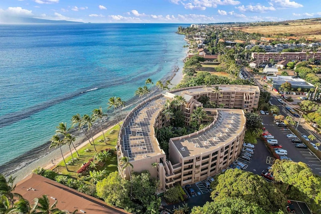 drone / aerial view featuring a water view and a beach view