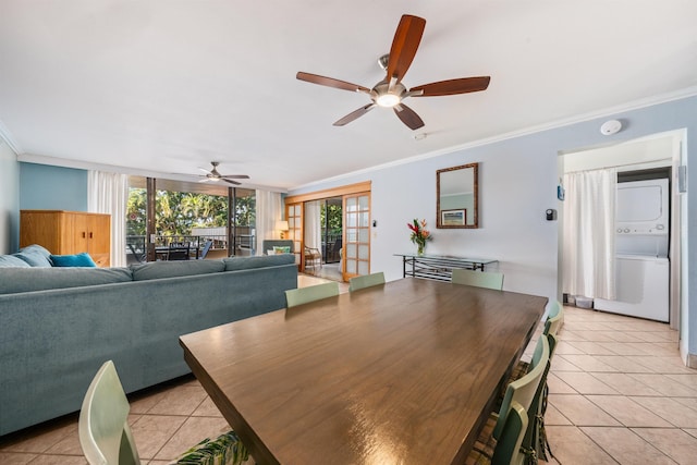 dining area with stacked washer / drying machine, ornamental molding, and light tile patterned floors