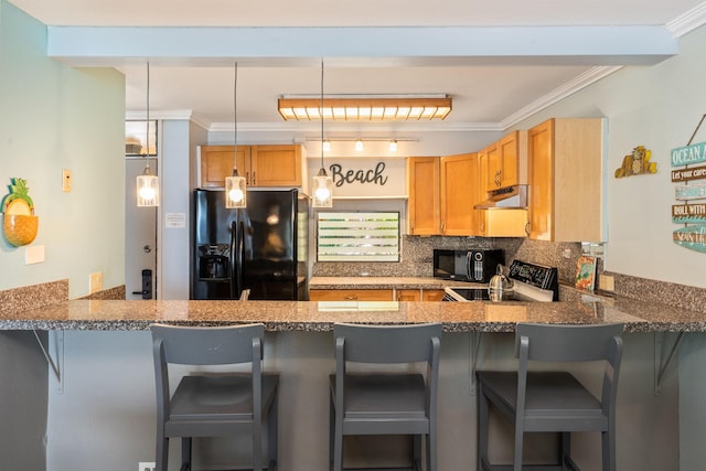 kitchen featuring black appliances, a breakfast bar, pendant lighting, and kitchen peninsula