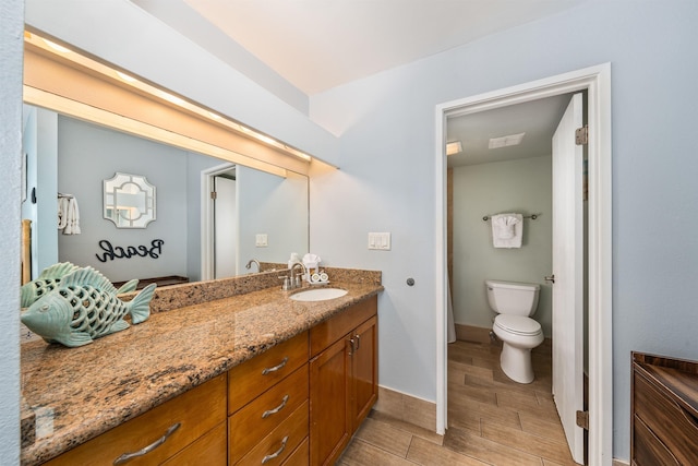 bathroom with vanity and toilet