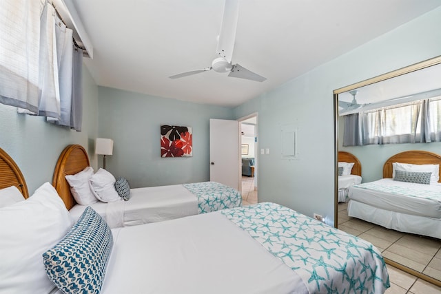 tiled bedroom featuring ceiling fan