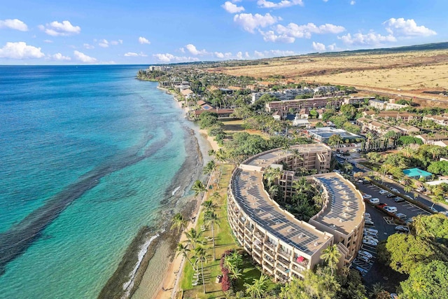 bird's eye view with a water view and a beach view