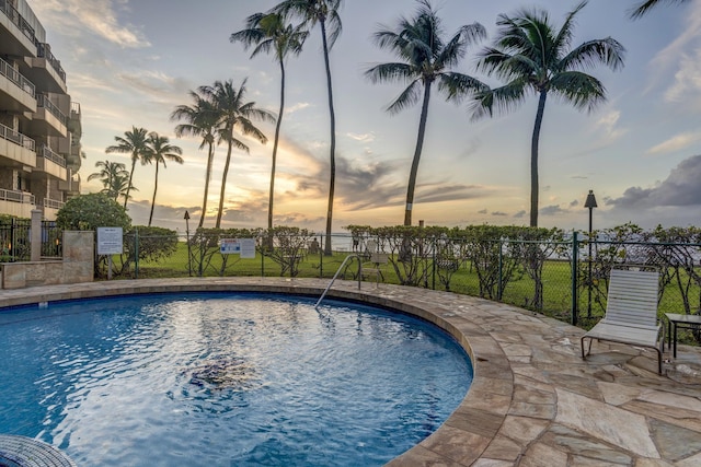 view of pool at dusk