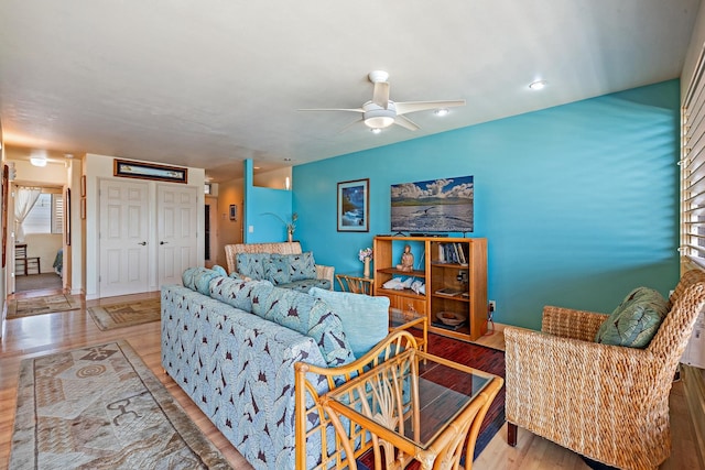 living room with light hardwood / wood-style floors and ceiling fan