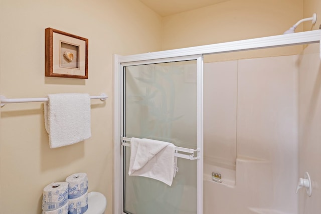 bathroom with a shower with door