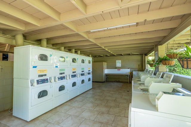 laundry area with washer and dryer and stacked washer and clothes dryer