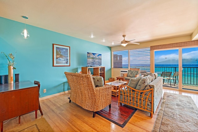 living room featuring ceiling fan and light wood-type flooring