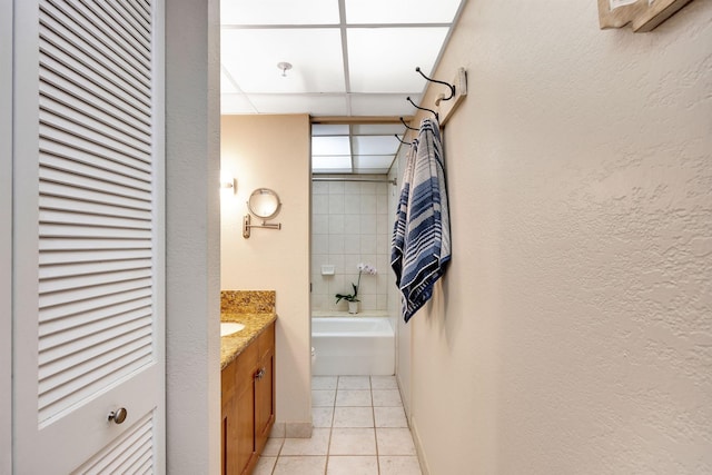 bathroom with vanity, a paneled ceiling, and tile patterned floors