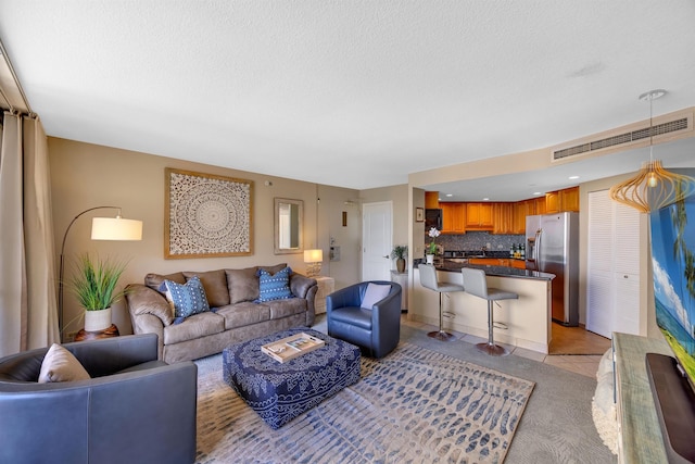 tiled living room with a textured ceiling